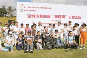 Disabled people run against the sea breeze to feel the warmth of the whole city